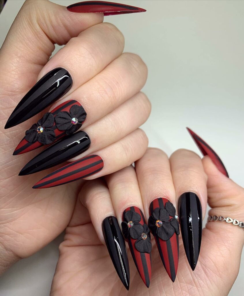 Black and Red Stiletto Nails with Floral Accents