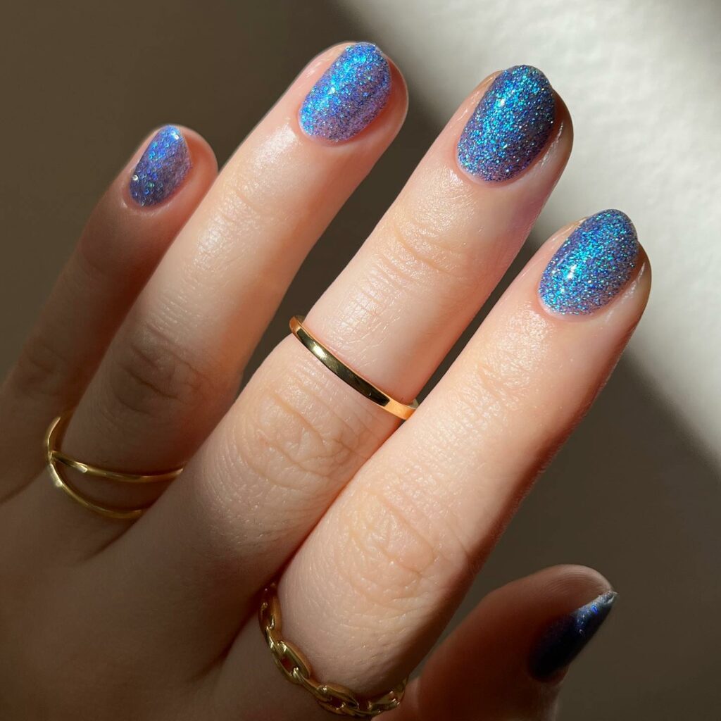 Glittery Blue Nails with a Luminous Finish