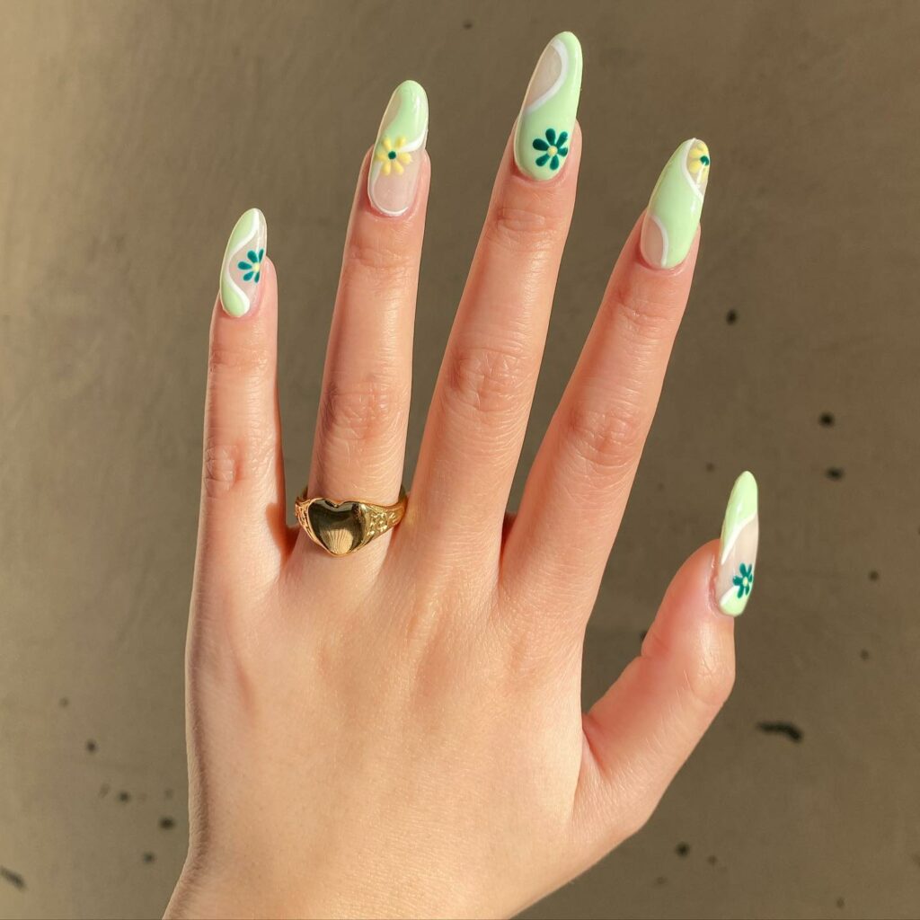 Artistically Rendered Flowers on Green Nails