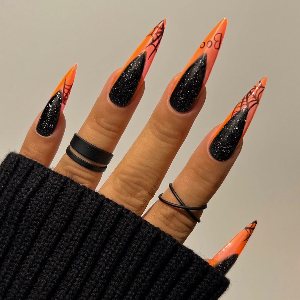 Orange Stiletto Nails with Spiderweb Accents